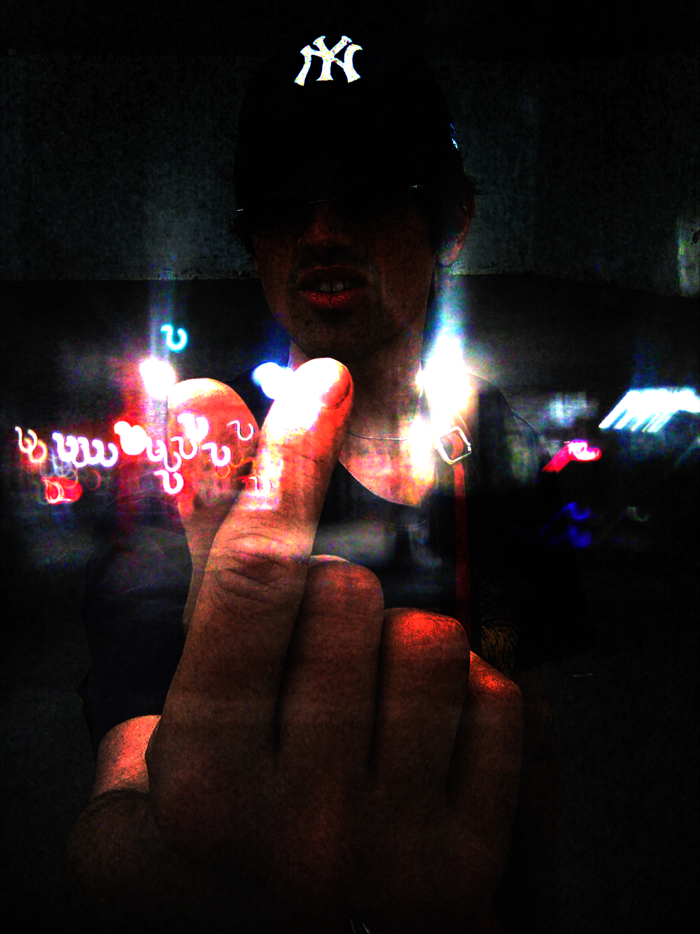 A frame from the Evil Star music video showing PJ making a heart shape overlayed with Brighton Beach Avenue