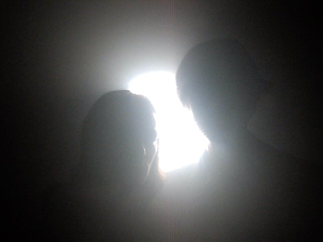 A frame from the planets music video showing PJ and Cody backlit in a foggy room