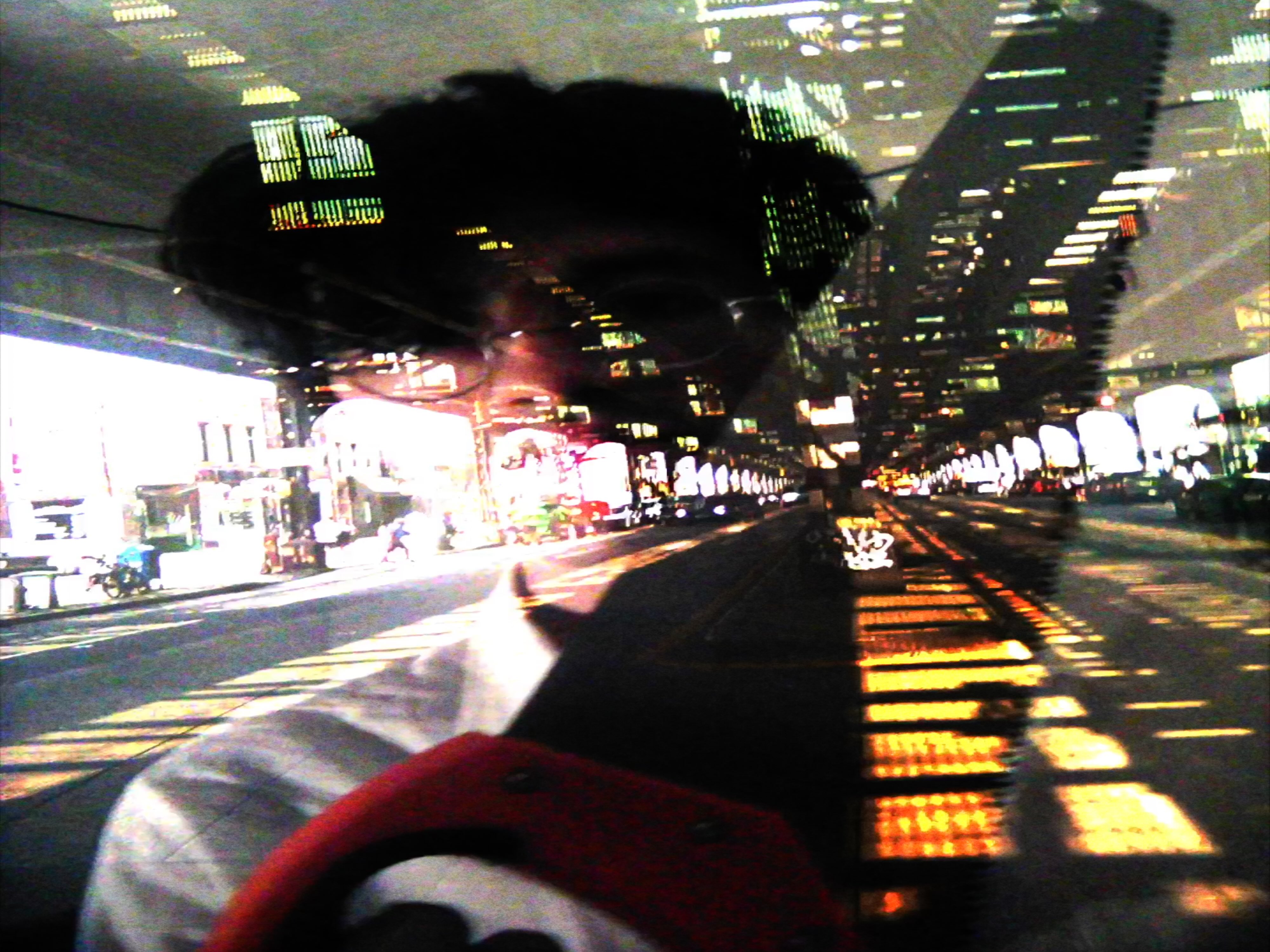 A frame from the Evil Star music video showing PJ with a saw overlayed with Brighton Beach Avenue